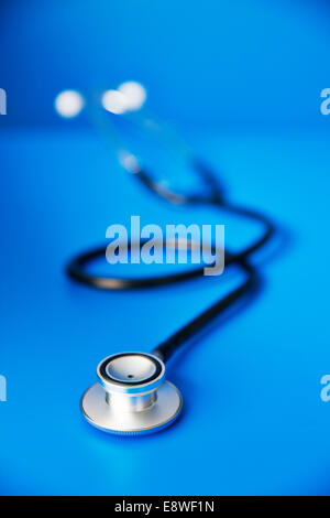 Close up of stethoscope on blue counter Stock Photo