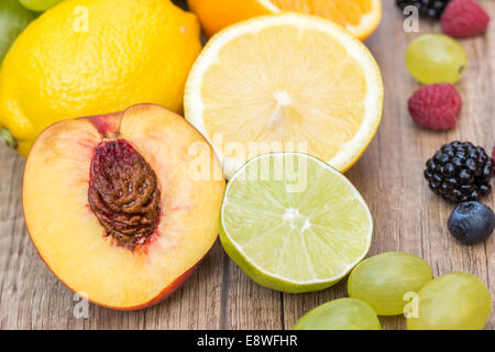 Assortment Of Fresh Exotic Fruits On Wood Table Stock Photo