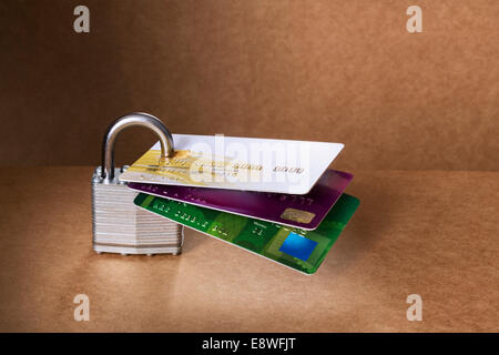 Credit cards attached to padlock Stock Photo