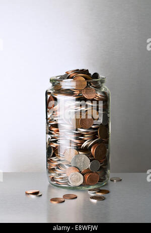 Change jar overflowing on counter Stock Photo