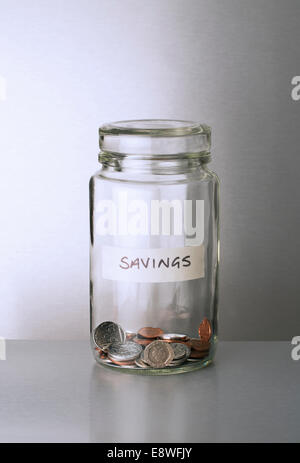 Savings change jar on counter Stock Photo