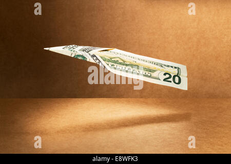 20 dollar bill folded into paper airplane Stock Photo