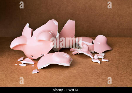 Broken piggy bank on counter Stock Photo