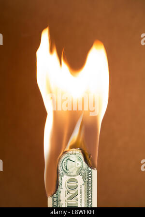 Folded dollar bill burning Stock Photo