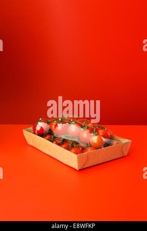 Close up of tomatoes shrink wrapped in plastic Stock Photo