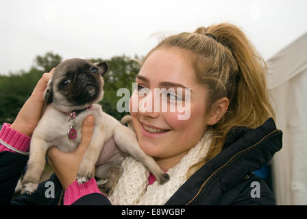 18 year old girl with her 13 week old pet dog - a Pug, Blackmoor, Hampshire, UK. Stock Photo