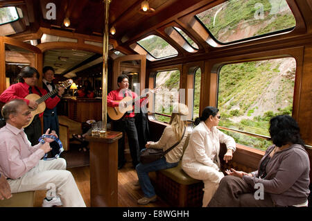 Peru Luxury train from Cuzco to Machu Picchu. Orient Express. Belmond. Observation car entertained by musicians and dancers in t Stock Photo