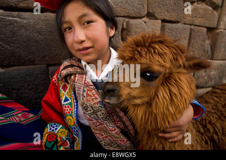 A girl and her llama beside the stone of 12 angles. This stone is well known, the peculiarity that made her famous is the presen Stock Photo