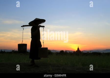 A burmese farmer is going home after a long day work in the fields Stock Photo
