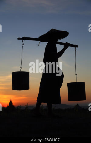 A burmese farmer is going home after a long day work in the fields Stock Photo