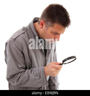 Man with raincoat is looking with magnifying glass over white background Stock Photo