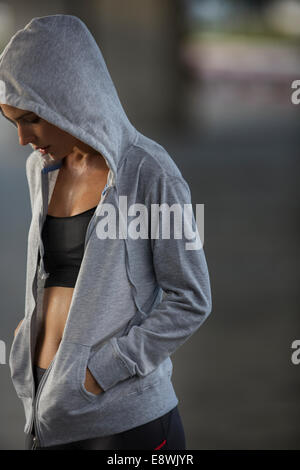 Woman standing outdoors after exercising Stock Photo