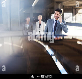 Business people walking in parking garage Stock Photo