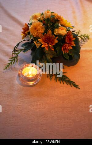 small table decoration of yellow and white flowers Stock Photo