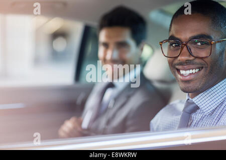 Smiling businessmen sitting in car Stock Photo