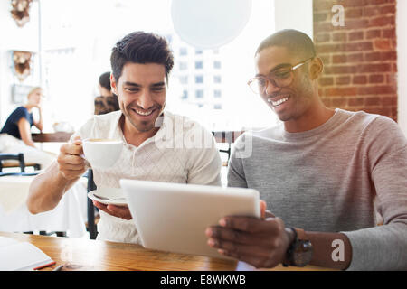 Businessmen using digital tablet in cafe Stock Photo