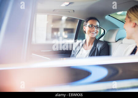 Businesswomen talking in car back seat Stock Photo