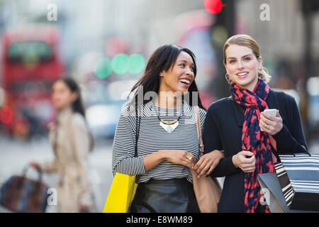 Women walking together down city street Stock Photo