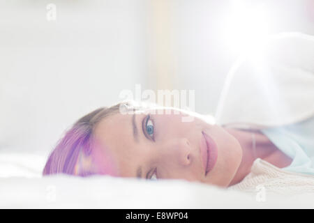 Close up of woman laying on bed Stock Photo