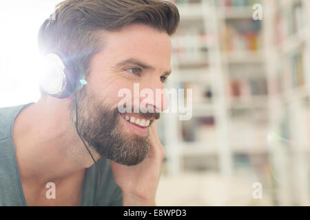 Man listening to music in living room Stock Photo