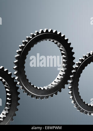 Close up of interlocking metal gears Stock Photo