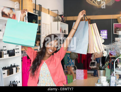 Woman carrying shopping bags in store Stock Photo