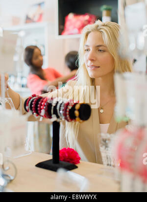 Woman shopping in clothing store Stock Photo