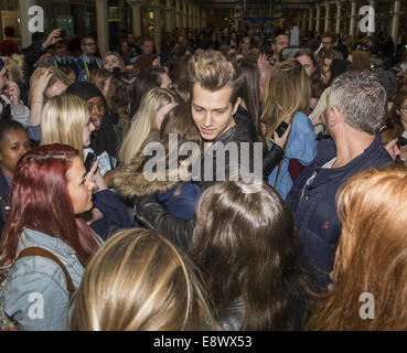 The Vamps arrive back in London following a trip to Paris, and treat their mob of fans to an impromptu gig at St. Pancras International station  Featuring: James McVey,The Vamps Where: London, United Kingdom When: 12 Apr 2014 Stock Photo