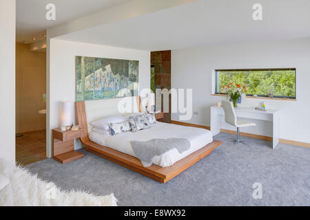 Modern bedroom with ensuite bathroom separated by partition wall, The Edge, Scotland Stock Photo