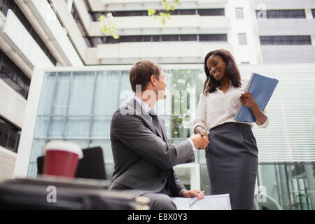 Business people talking outside of office building Stock Photo