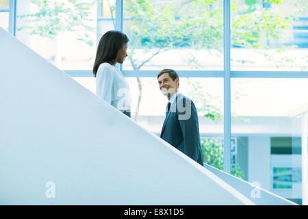 Business people walking up and down the office building stairs Stock Photo