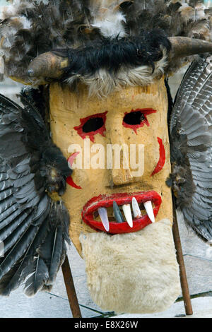 A close-up of a traditional Kuker mask reveals the intricate ...