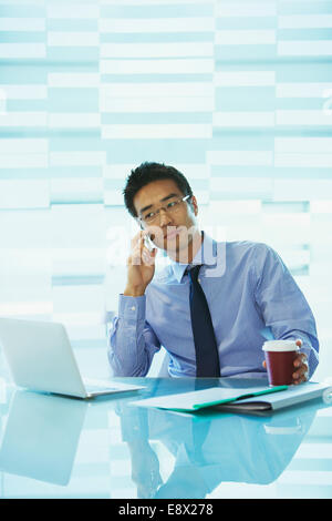 Businessman using laptop in office building cafe Stock Photo