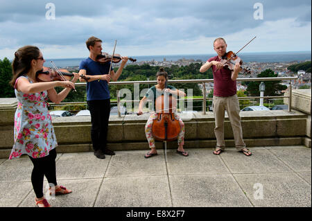 The Solem String Quartet string quartet performing an impromptu outdoor concert outside the National Library of Wales during their residency at Aberystwyth MusicFest 2014 Stock Photo