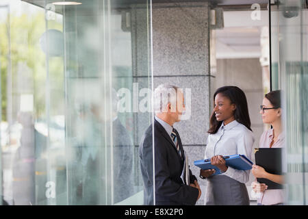 Business people talking in office building Stock Photo