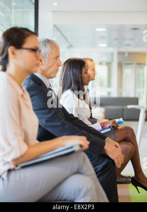 Business people sitting in office together Stock Photo