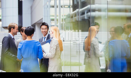 Business people talking outside of office building Stock Photo