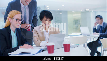 Business people working on laptop at table Stock Photo