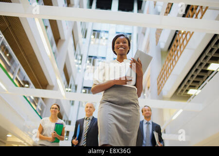 Business people walking in office building Stock Photo