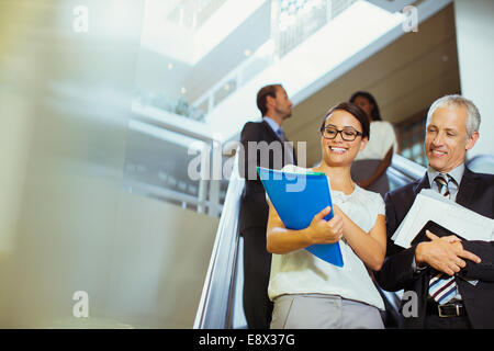 Business people looking over documents in office building Stock Photo
