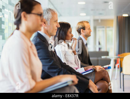 Business people sitting in office together Stock Photo