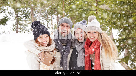 Friends hugging in the snow Stock Photo