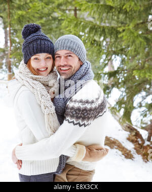 Couple hugging in the snow Stock Photo