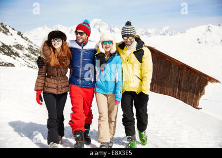 Friends walking in the snow together Stock Photo