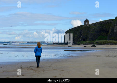 Stock Photo - Red haired woman walking alone on beach, Downhill, County Derry, Londonderry, Northern Ireland. ©George Sweeney /A Stock Photo