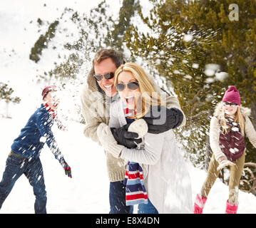 Family having a snowball fight in the snow Stock Photo