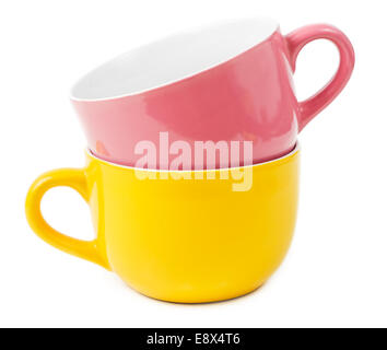 Stacked yellow and purple mugs isolated on white background Stock Photo