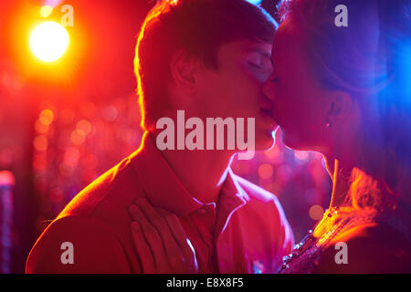 Romantic couple kissing on dance-floor in nightclub Stock Photo