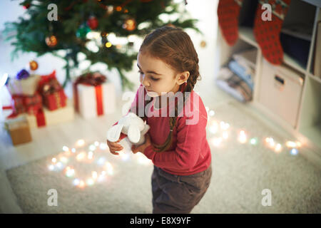 Cute girl with toy playing at home Stock Photo