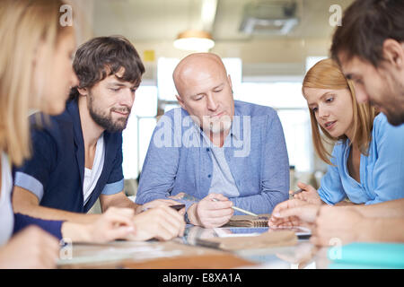 Group of pensive business people having meeting in office Stock Photo